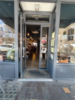 Grey framed glass door with silver handle. Pull handle on right to open.