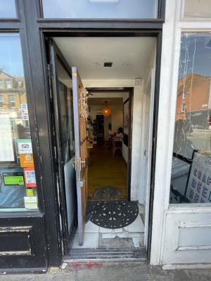 Black glass door in front front. Handle on right. Push to open.