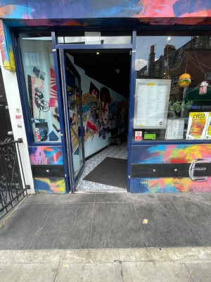 Blue metal framed glass door ahead. Push on right to open.