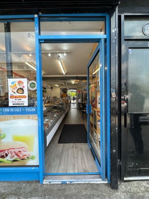 Blue framed glass door ahead. Push blue handle on left to open.