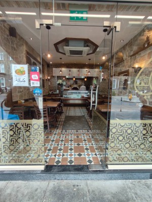 Single glass door. Push silver handle on left to open.