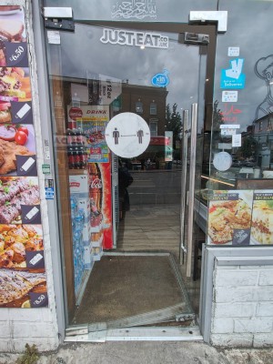 Glass door. Push silver handle on right to open.
