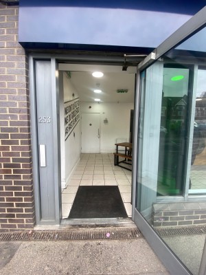 Glass door, with grey doorframe. Handle on left. Pull to open.