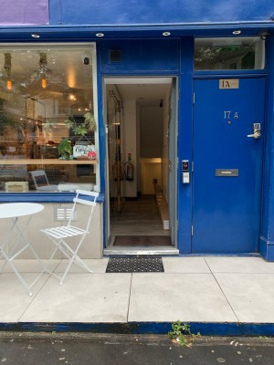 From sidewalk facing venue. One step up to landing followed by main entrance door.