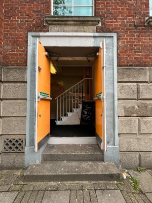 Grey double doors. Pull from centre to open.
