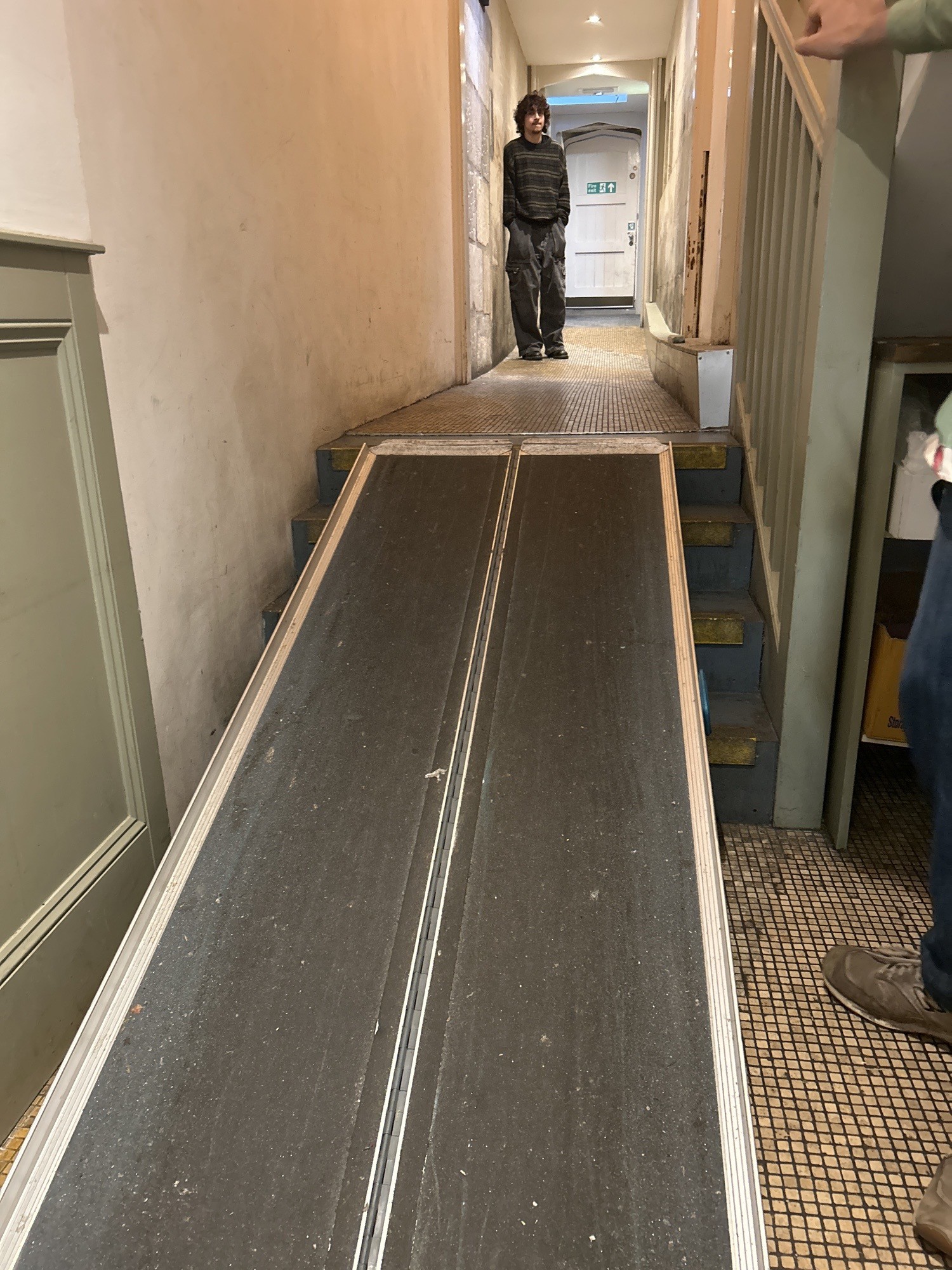 the ramp, too steep for anyone to push themselves up. staff were happy to help but still not properly accessible.