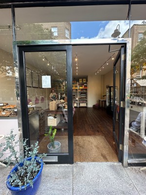 Glass doors with black doorframe. Push from centre to open.