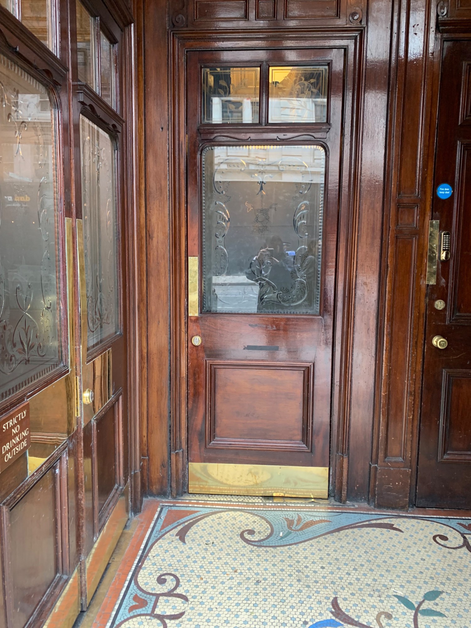 From alternative entrance doorway, looking straight. Right foyer ahead. Doorway to right side area at back wall. Doorway to main area on left wall.