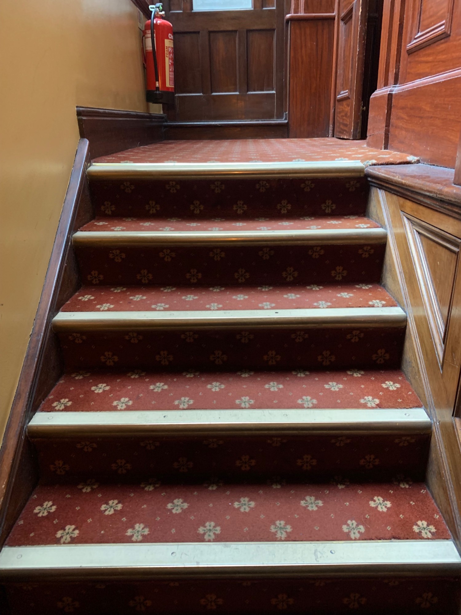 From back wall, looking left. Stairs continue up to top of staircase.