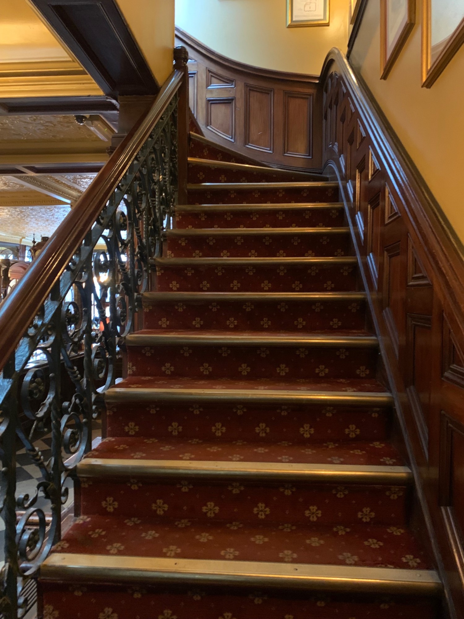 From back wall, looking left. Stairs continue going up to wall at back. Wooden handrails along left and right sides of staircase.