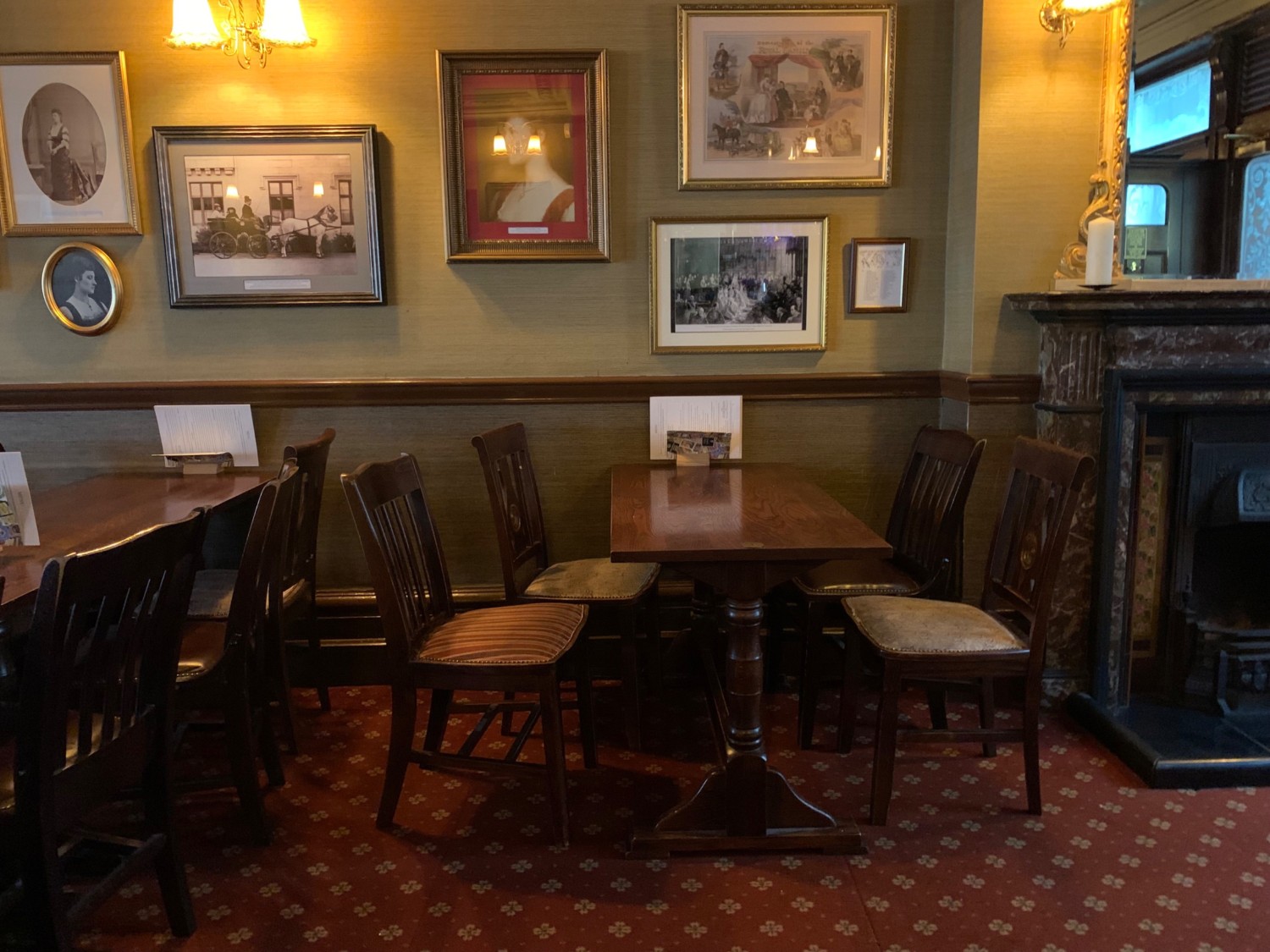 From end of counter, looking right. Tables and chairs along back wall.