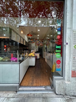 Glass door. Push open via handle on left.