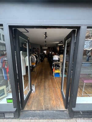 Black framed glass doors. Push open via handles in centre.
