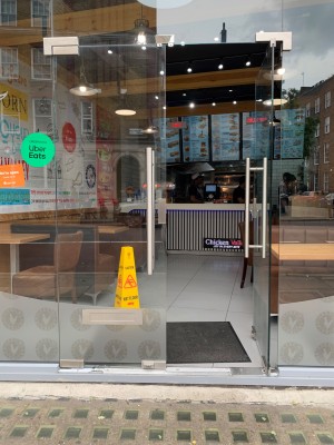 Double glass doors with silver metal handles in center. Push from handles to open.