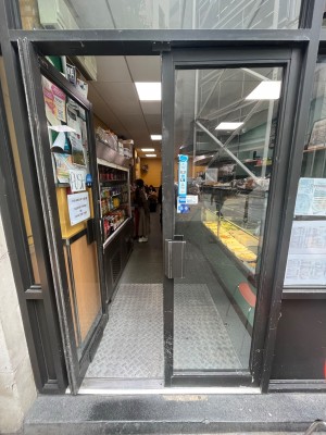 Grey framed glass doors ahead. Push open via handles in centre.