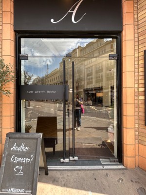 Double glass doors. Push black vertical handles in middle to open.