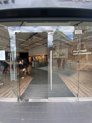 Double glass door, silver handles at centre. Push to open.