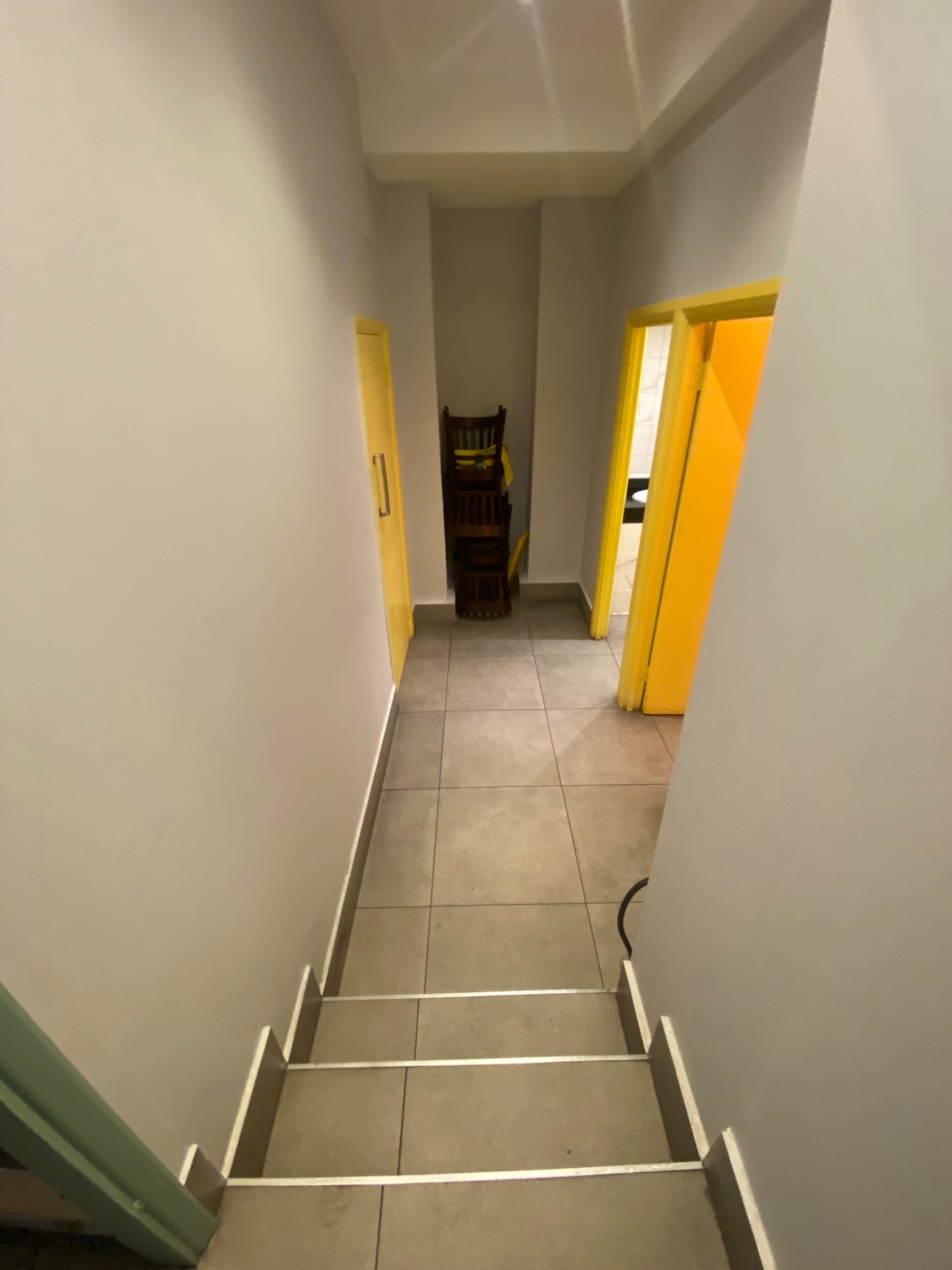 From archway, facing left. Second flight of stairs in front.