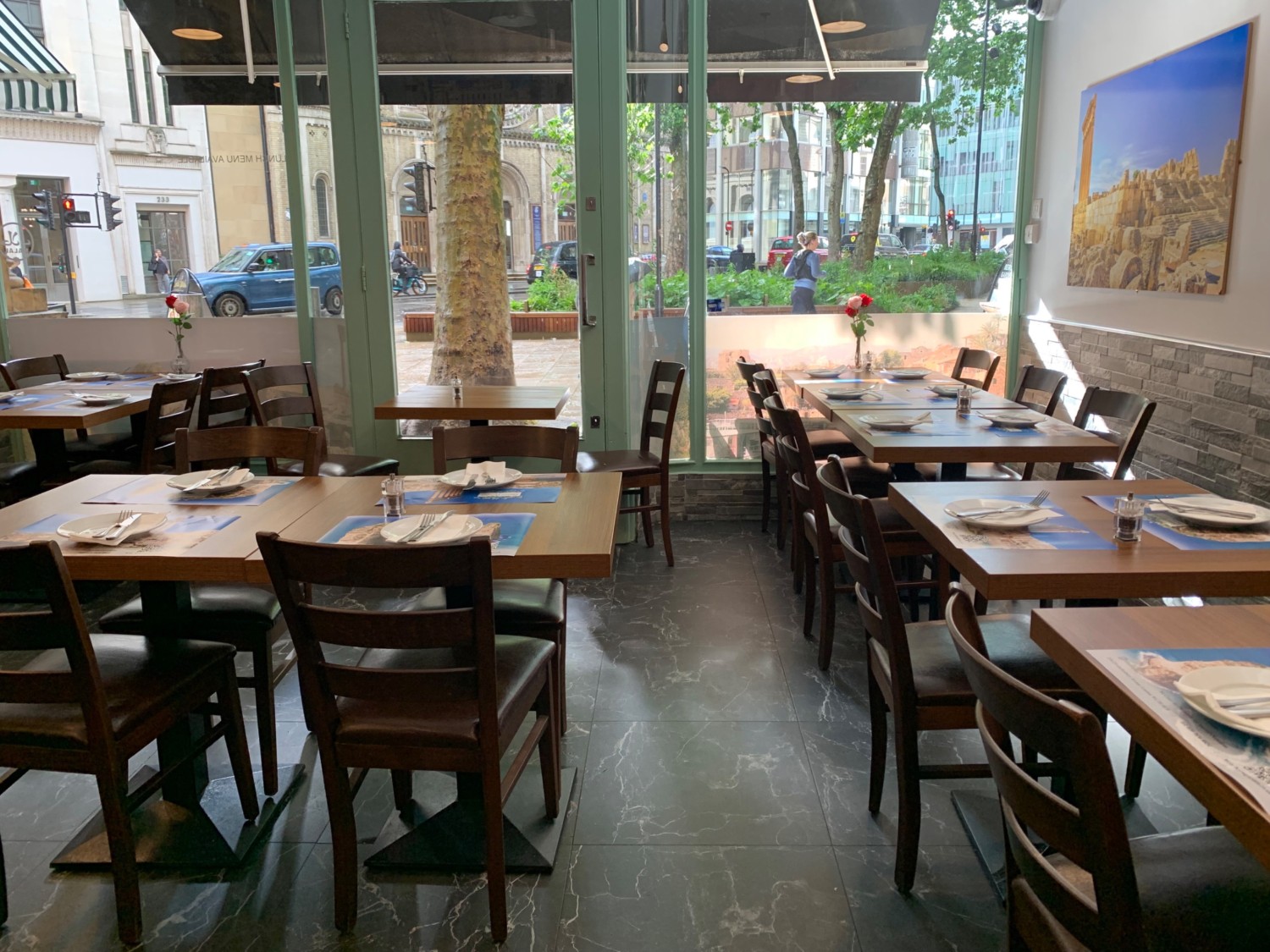 From archway, looking right. Tables and chairs along right and back walls, and to left.