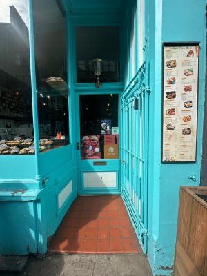 Blue gated door. Push from left to open.