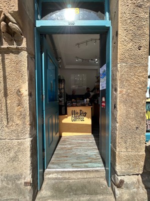 Single teal wooden door. Push from right to open.
