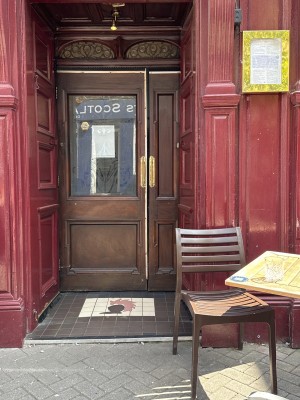 Small step up to first set of double doors that open inwards. Second set of double doors open outwards from the centre.