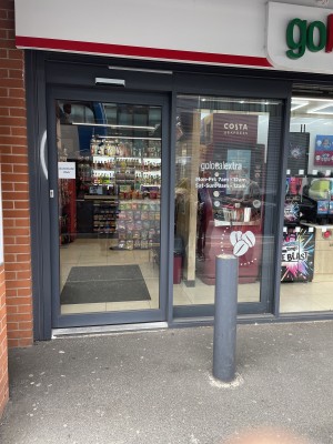 Wide automatic opening door with small bump up from street level