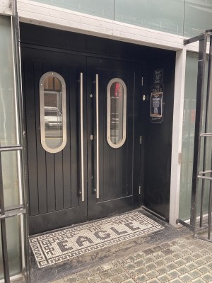 Closed dark double doors with handles and low bump