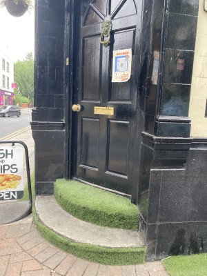 Black wooden door up two steps