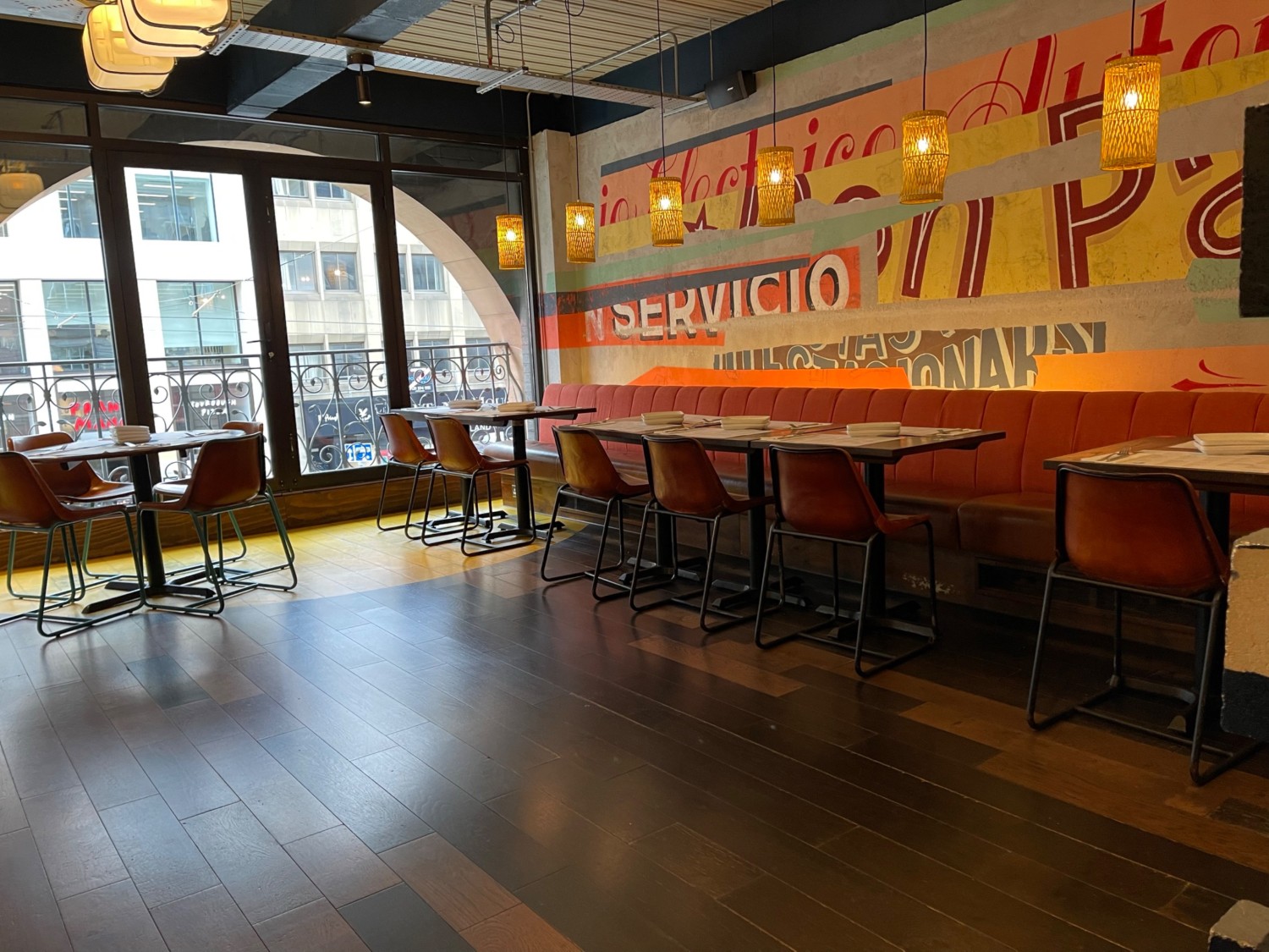 Open space with tables and chairs by wall and window