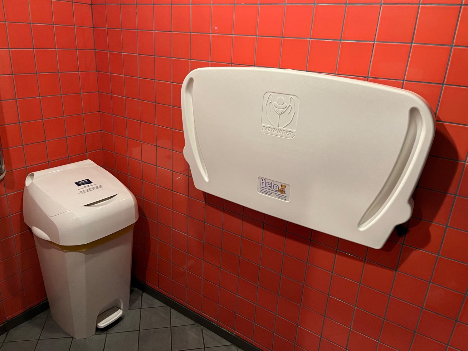The pedal-operated nappy bin and baby changing facilities on the right hand side