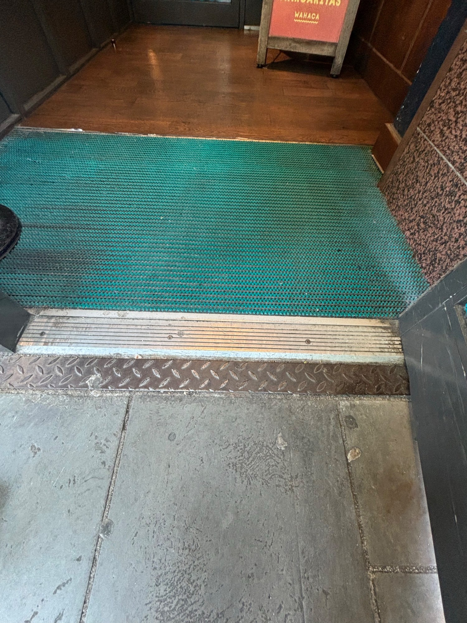 Small metal bump to the entry.
Texture carpet area after first front door.