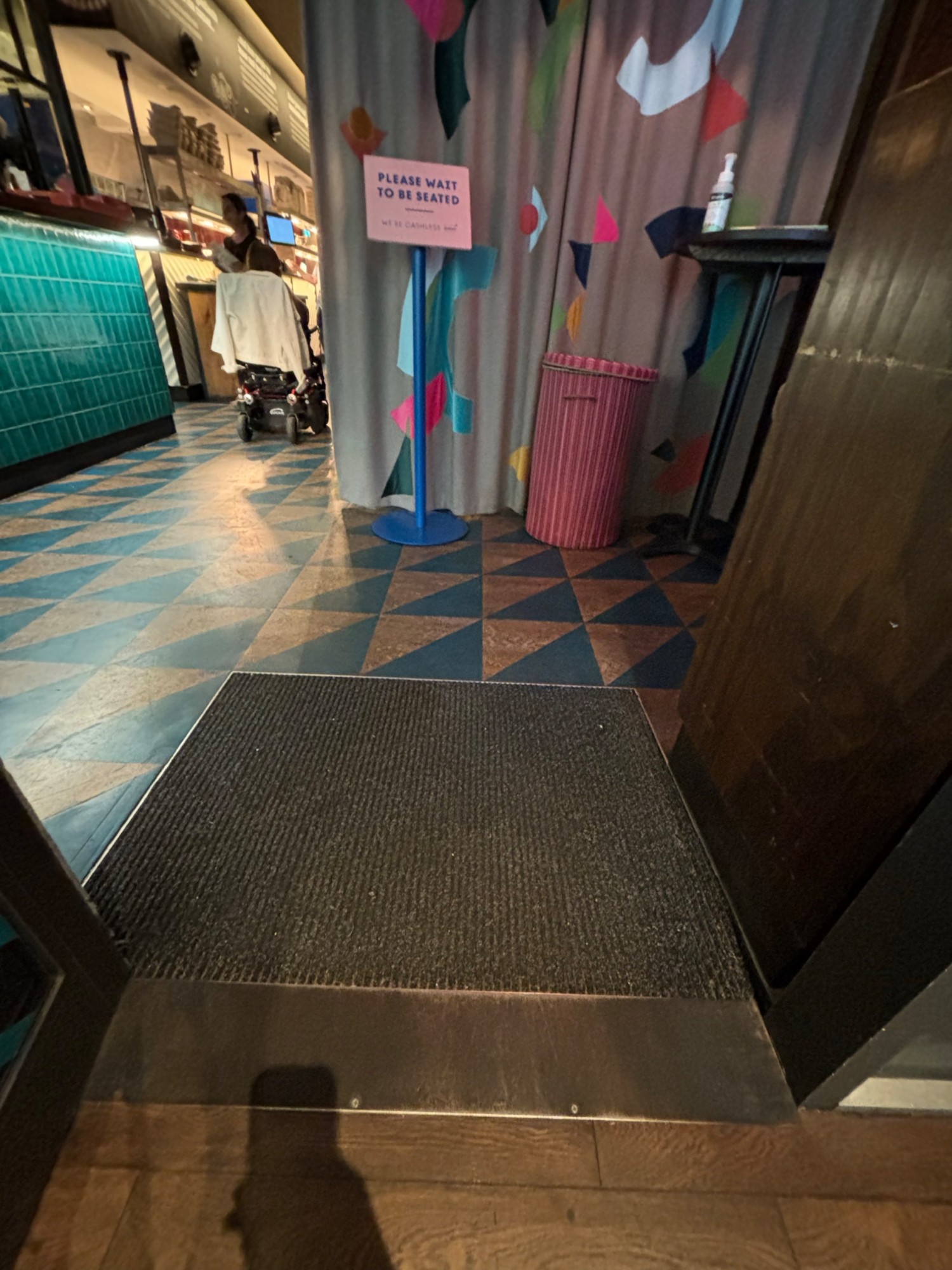 Small metal bumb to the second door entrance 
Carpet area after the door opens