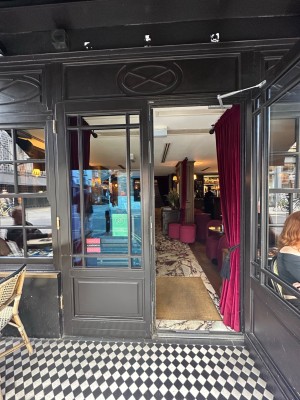 Grey and glass panelled doors. Pull handle on right-hand centre of door to open. Red curtains after doors. Slide open from centre.