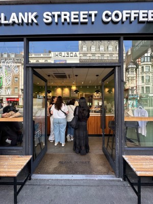 Glass doors with black doorframes. Black handles in centre of doors, push to open.