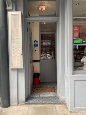 Single blue wooden door with glass panel.
Push from right of door to open.