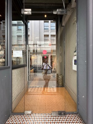 First glass door with festival silver handle to left, pull to open.
