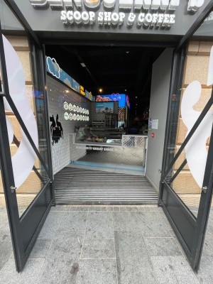 Black glass door with handle in centre, pull to open.