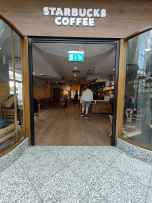 Facing entrance. Black framed open archway ahead.