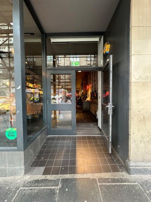 Grey and glass panelled doors with silver handle in centre of right-hand door. Pull to open.