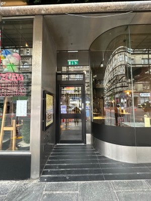 From pavement looking straight at opening ahead. Built-in ramp leading up to entrance door.