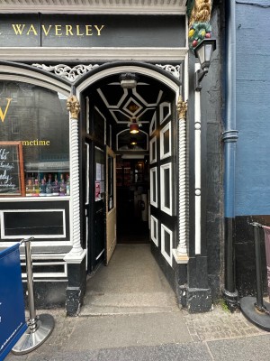 Black and white door, push from left to open.