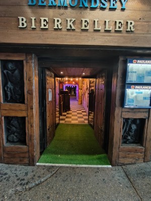 Facing wooden framed entrance door. Pull from centre of doors to open.