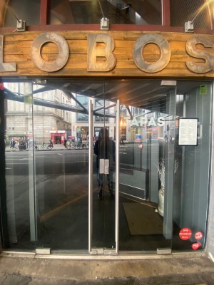 Double glass door, vertical silver handles at centre. Push to open.