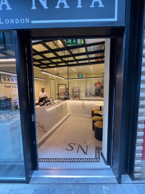 Black framed glass sliding door. Slide towards the left to open.