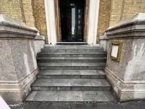 Steps ahead lead up to doors.