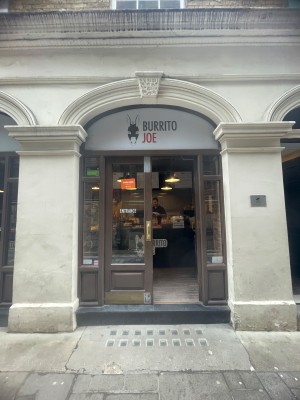 Glass doors with brown frame. Push in center to open.