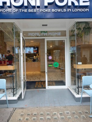 Glass double door with vertical metal handle in middle. Pull to open.