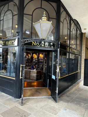 Black and glass-panelled doors. Gold metal handles in centre. Pull to open.