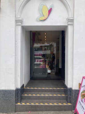 Open archway ahead. 3 steps up to main entrance.